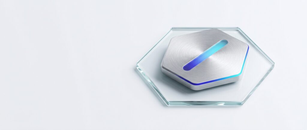 A brushed aluminium hexagonal security key resting on a clear glass hexagon tile, lit by a thin indigo to cyan light line, on a flat light grey background.
