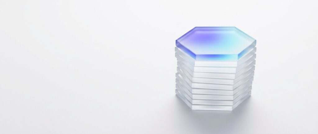 Stack of 9 thin frosted glass hexagon plates, one lit in indigo to cyan, on a light grey backdrop